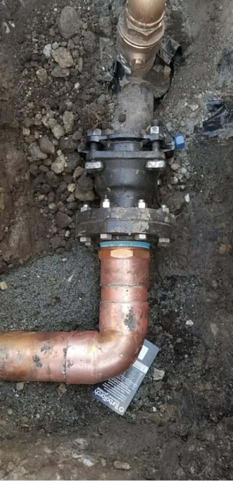 New copper water service tied into the main with a flanged gate valve