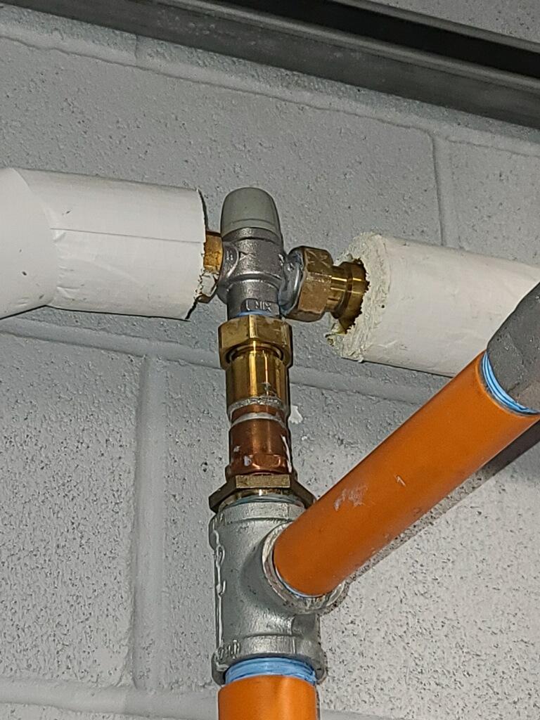Tempering valve installed on insulated hot water lines
