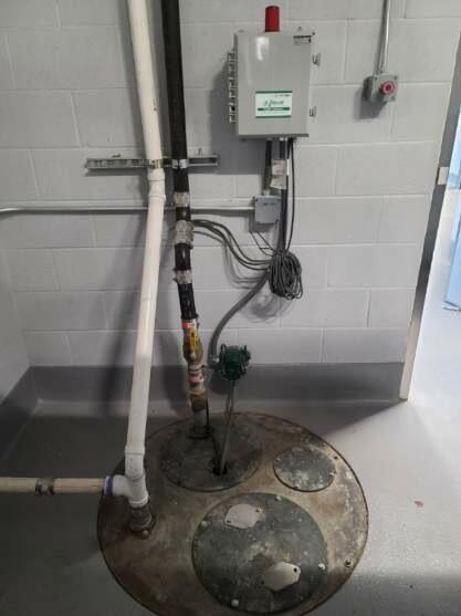 Commercial sewage ejector basin with control panel and high-water alarm